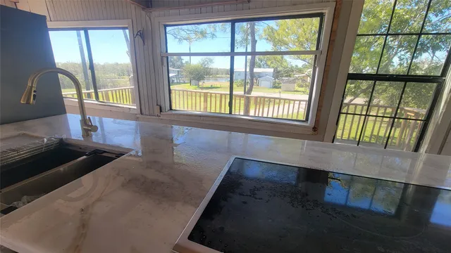 a view of outdoor space with wooden floor and windows
