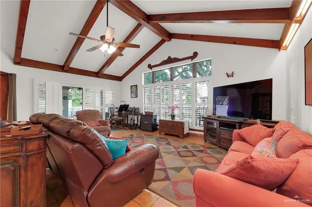 a living room with furniture a flat screen tv and a large window
