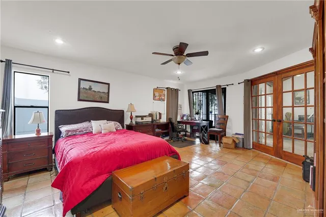 a bedroom with a bed a table and chair