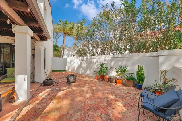 a backyard of a house with outdoor seating