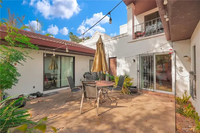 a view of a chair and tables in patio of the house