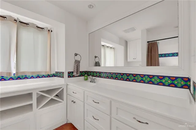 a bathroom with a double vanity sink and a mirror