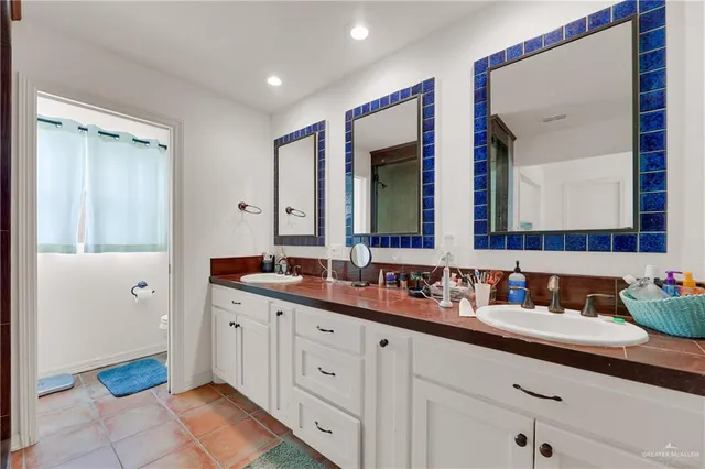 a bathroom with a double vanity sink and a mirror