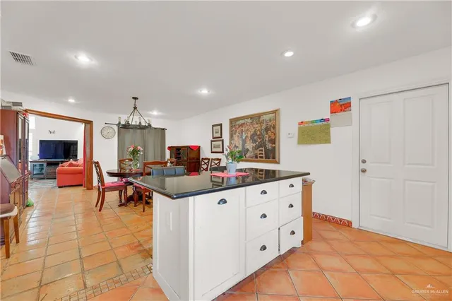 a living room with furniture and a kitchen