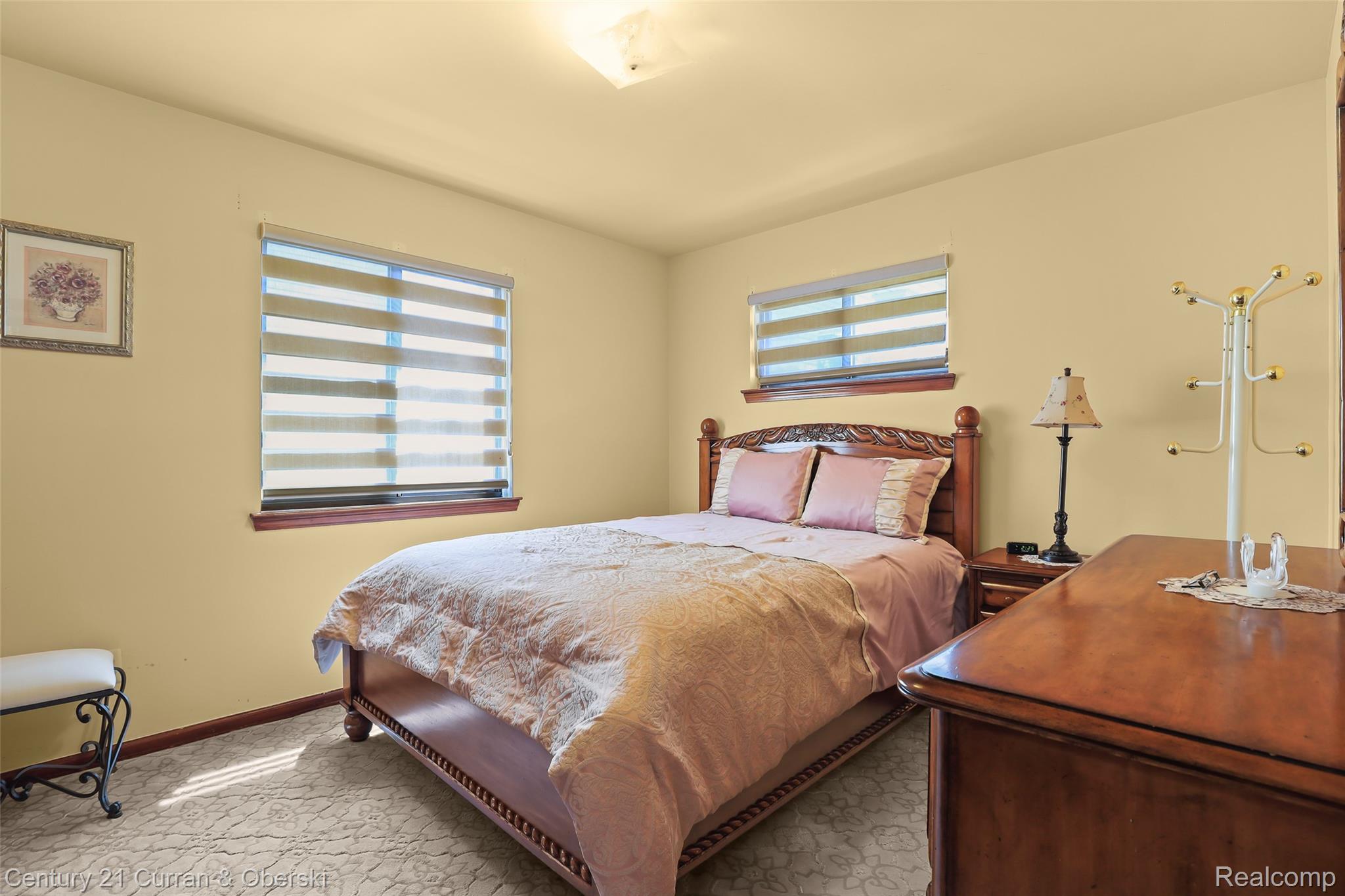 5296 Chase Road Dearborn, MI 48126 - Photo 12 of 36 Bedroom featuring a ceiling light fixture, two windows with horizontal blinds, and patterned carpeting