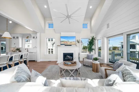 a living room with furniture fireplace and a large window