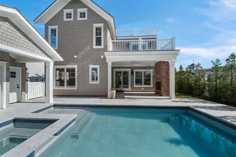 a view of a house with backyard porch and furniture