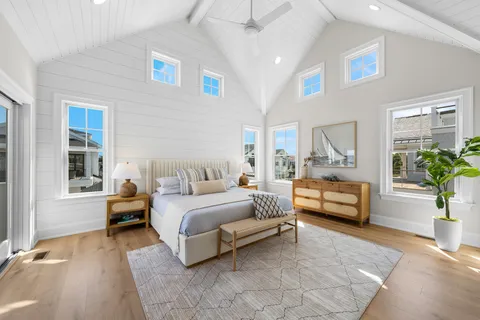 a bedroom with a large bed and a balcony