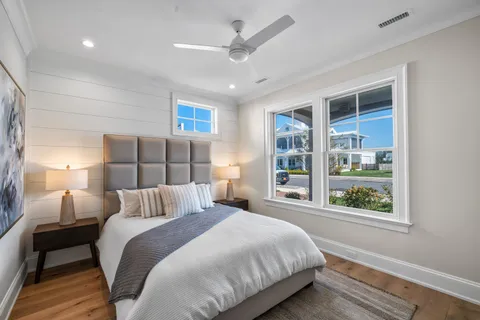 a bedroom with a bed and a painting on the wall