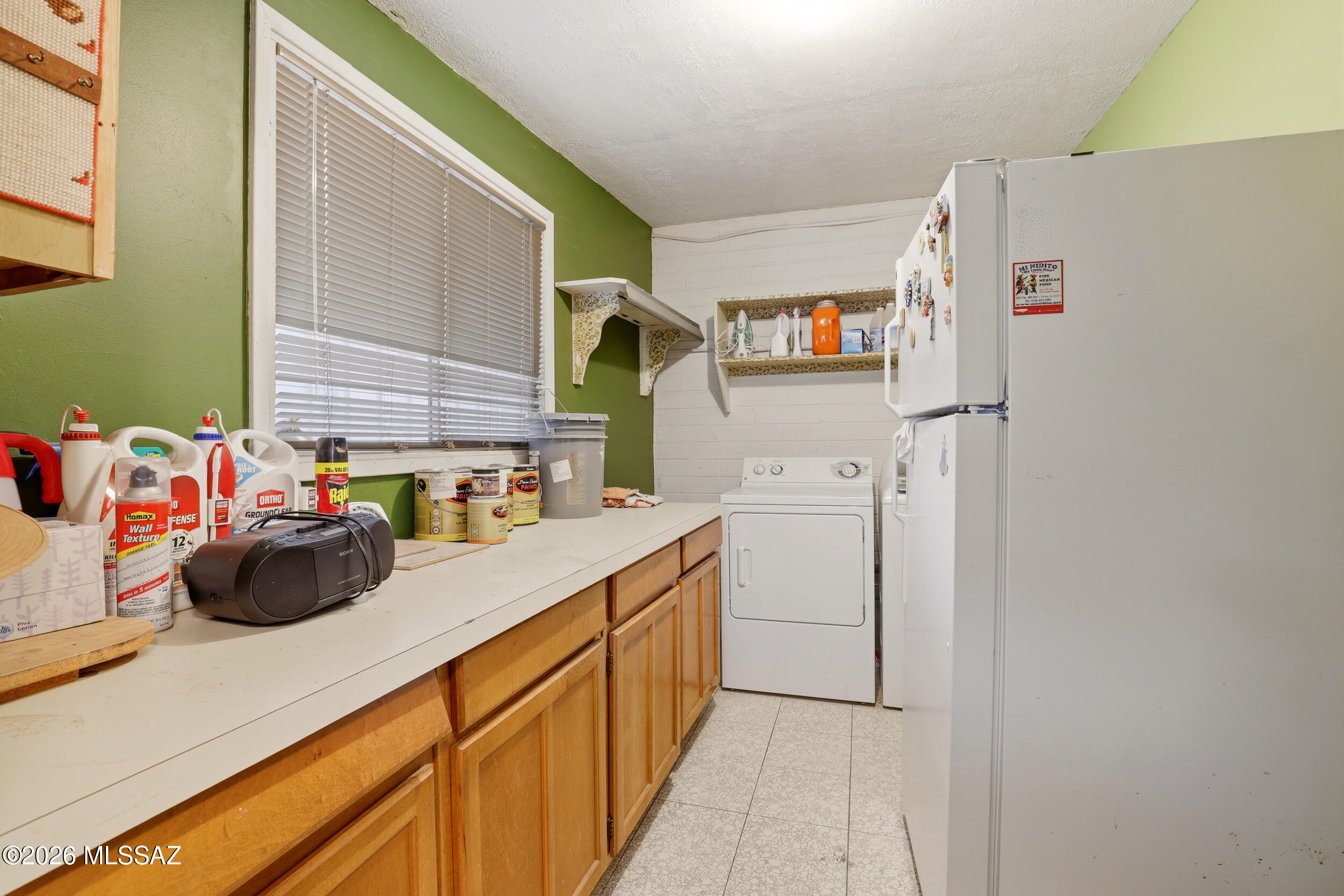 3632 East Juarez Street Tucson, AZ 85713 - Photo 23 of 37 Laundry Room with counter space and cabinets, extra fridge