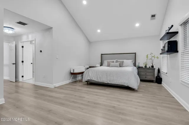 a bedroom with a bed and flat screen tv