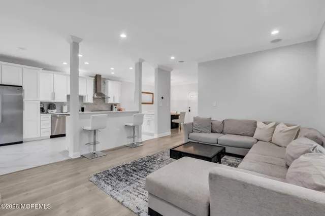 a living room with furniture and kitchen view