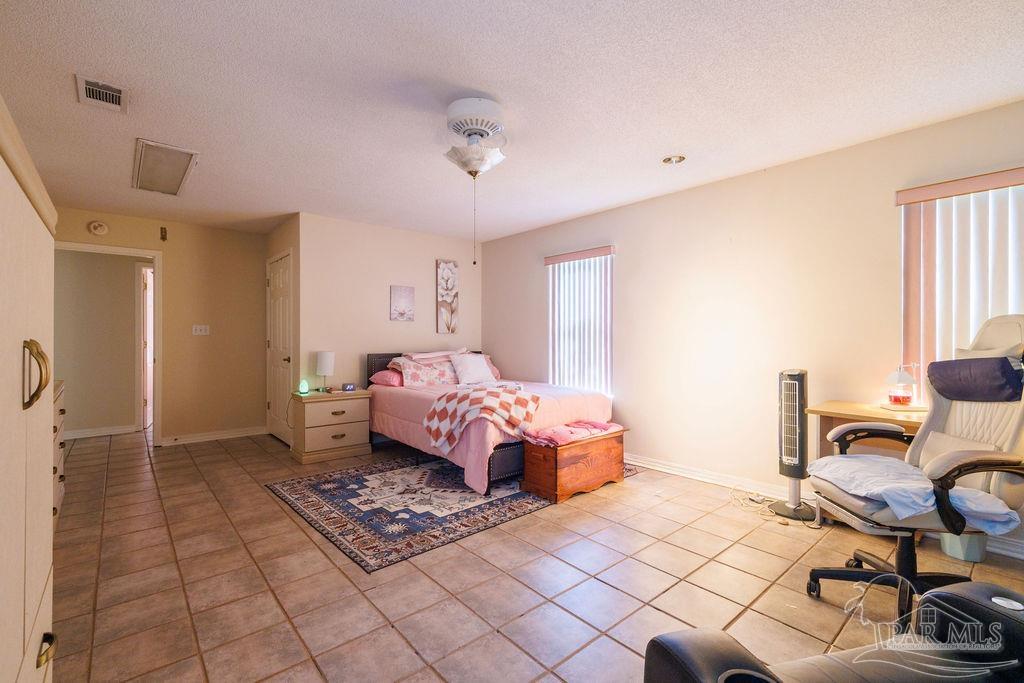 1590 Jacks Branch Road Cantonment, FL 32533 - Photo 11 of 19 a bedroom with furniture and a window