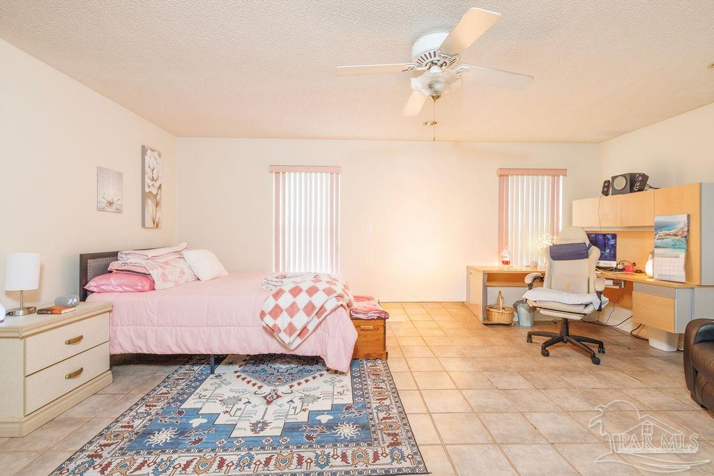 1590 Jacks Branch Road Cantonment, FL 32533 - Photo 12 of 19 a bedroom with a bed and a chandelier