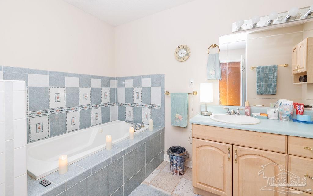 1590 Jacks Branch Road Cantonment, FL 32533 - Photo 15 of 19 a bathroom with a tub sink and mirror