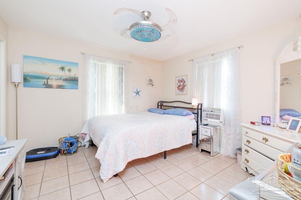 1590 Jacks Branch Road Cantonment, FL 32533 - Photo 2 of 19 a bedroom with a bed and a chandelier