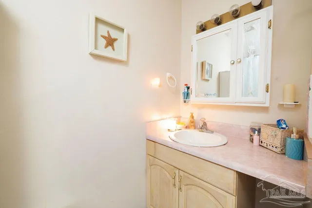 a bathroom with a sink vanity and a mirror