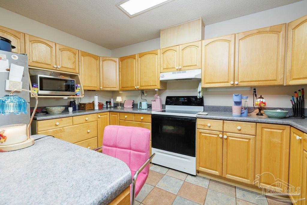 1590 Jacks Branch Road Cantonment, FL 32533 - Photo 7 of 19 a kitchen with stainless steel appliances granite countertop a stove top oven a sink dishwasher and cabinets with wooden floor
