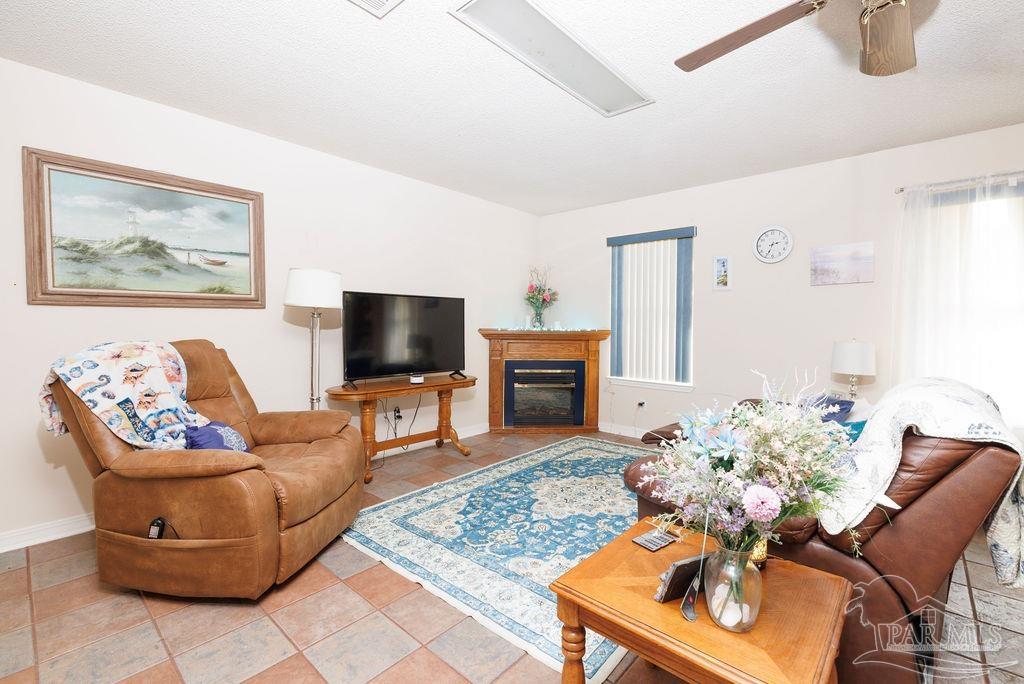 1590 Jacks Branch Road Cantonment, FL 32533 - Photo 9 of 19 a living room with furniture and a flat screen tv