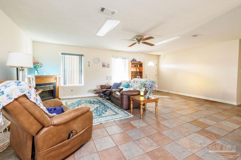 1590 Jacks Branch Road Cantonment, FL 32533 - Photo 10 of 19 a living room with furniture and a table