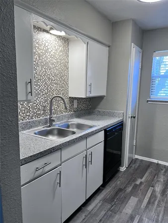 a kitchen with a sink and cabinets