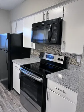a kitchen with a stove and a microwave