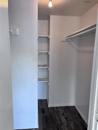a view of walk in closet with empty racks