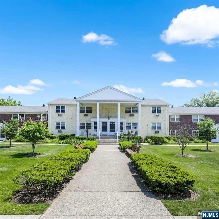 95 Regency Park, Unit 95 Ramsey, NJ 07446 - Photo 3 of 13 front view of a house with a yard