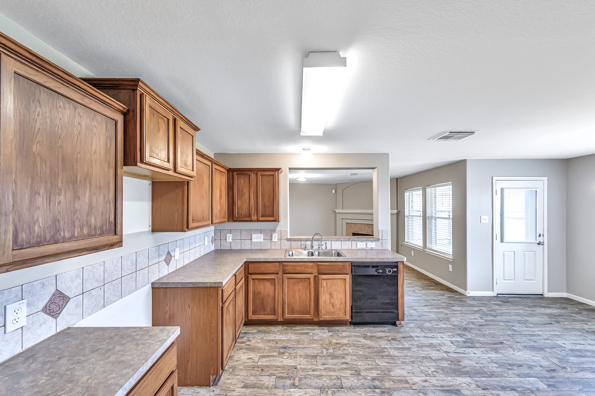 20243 Sunset Ranch Drive Katy, TX 77449 - Photo 11 of 36 a kitchen with a sink stove and cabinets