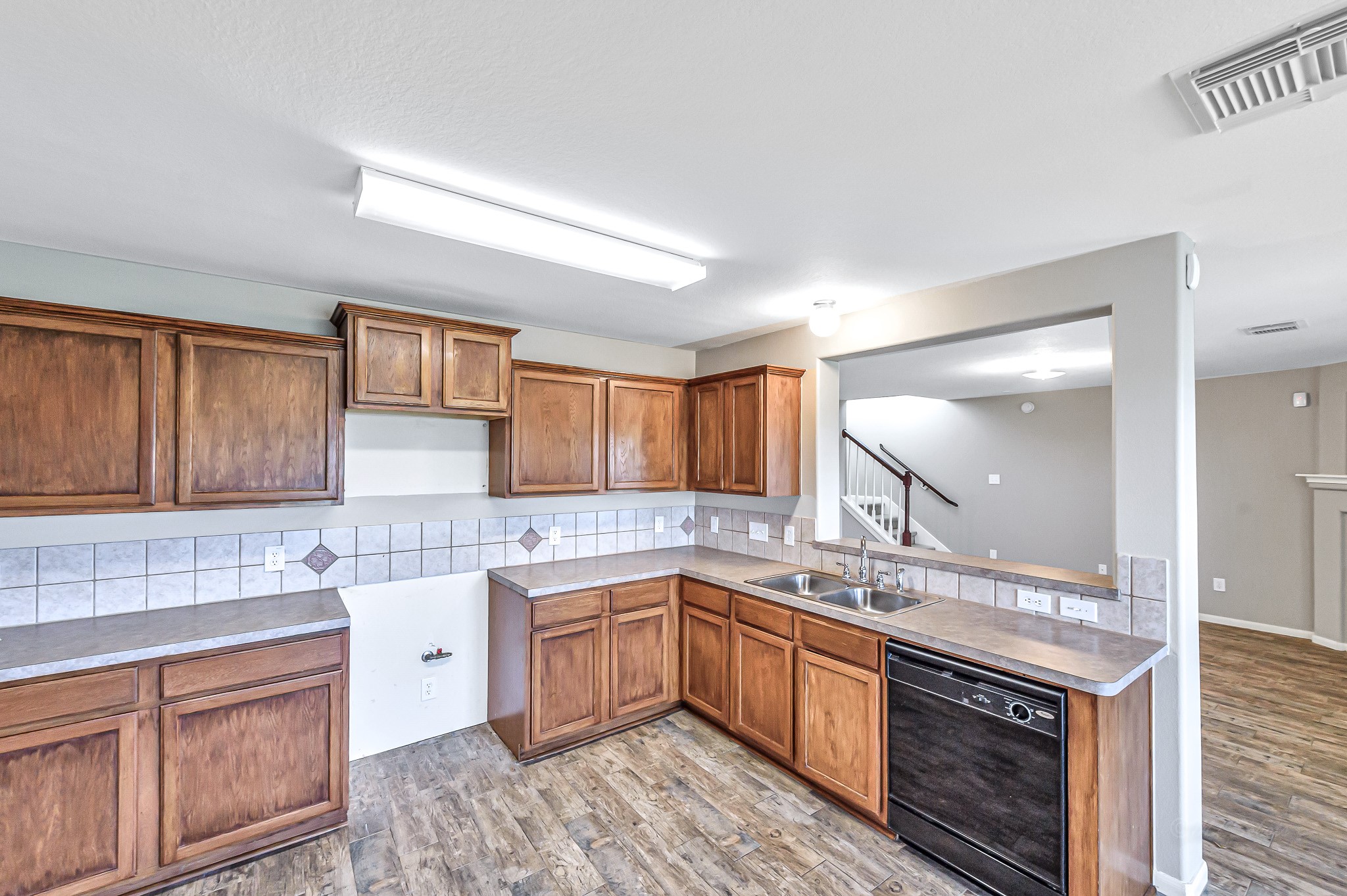 20243 Sunset Ranch Drive Katy, TX 77449 - Photo 12 of 36 a kitchen with a sink stove and cabinets