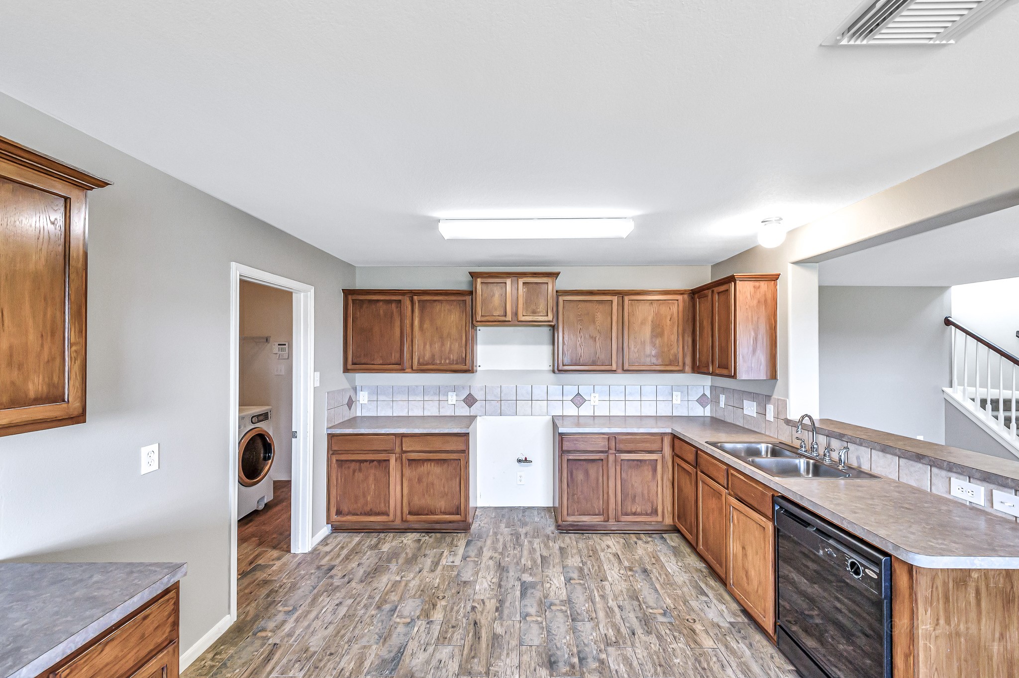 20243 Sunset Ranch Drive Katy, TX 77449 - Photo 15 of 36 a large kitchen with a stove top oven and sink