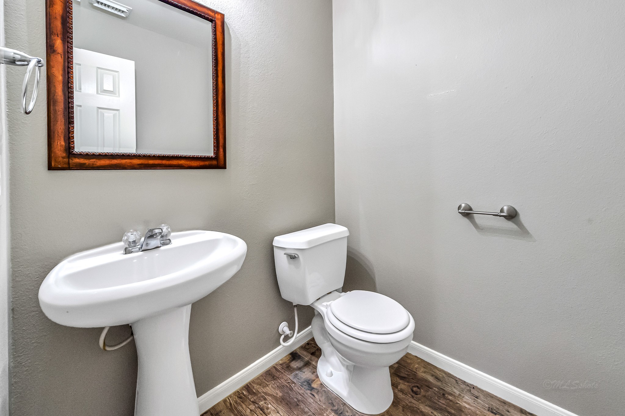 20243 Sunset Ranch Drive Katy, TX 77449 - Photo 18 of 36 a bathroom with a sink a mirror and a toilet