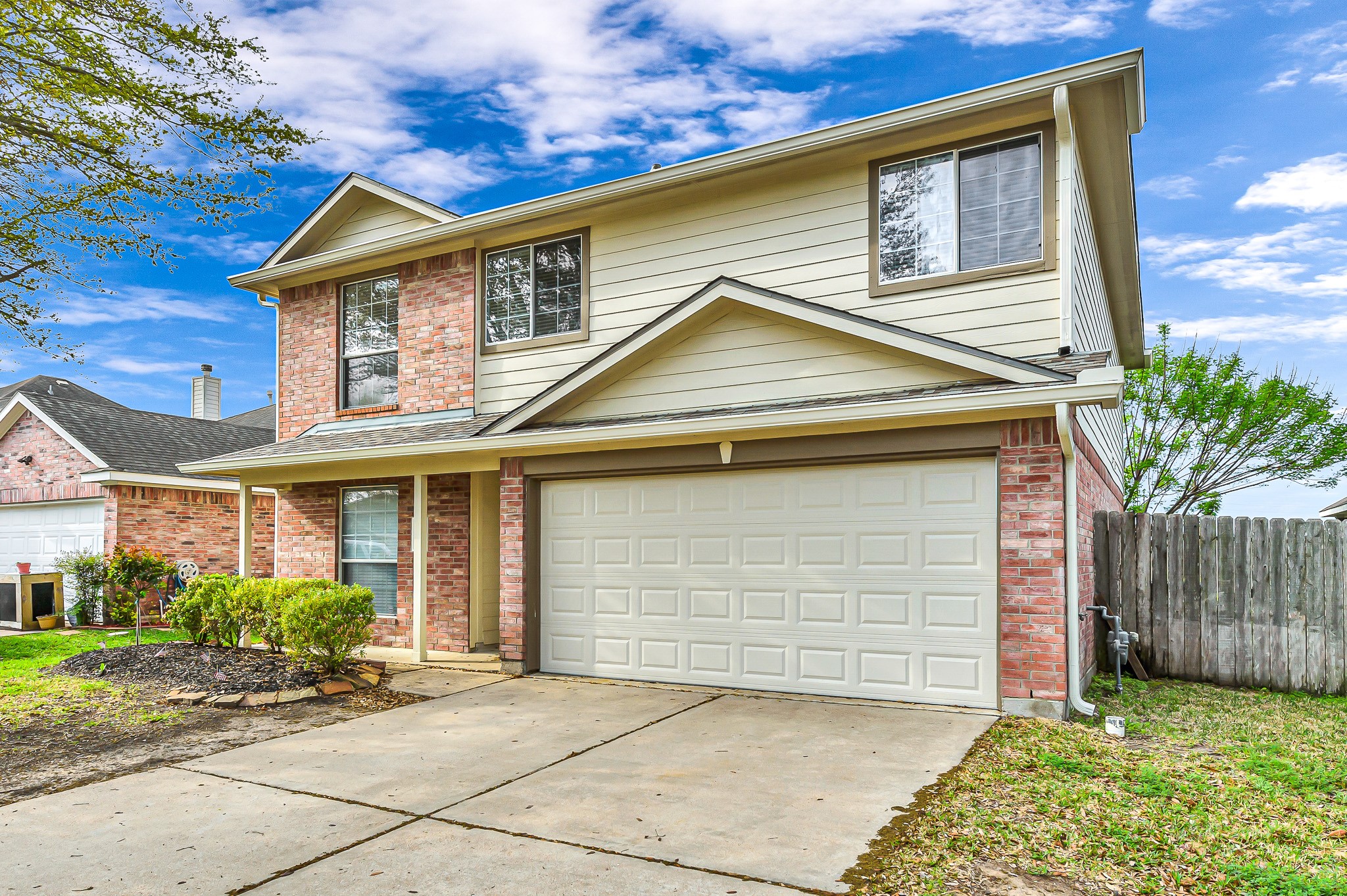 20243 Sunset Ranch Drive Katy, TX 77449 - Photo 2 of 36 a front view of a house with a garden and garage