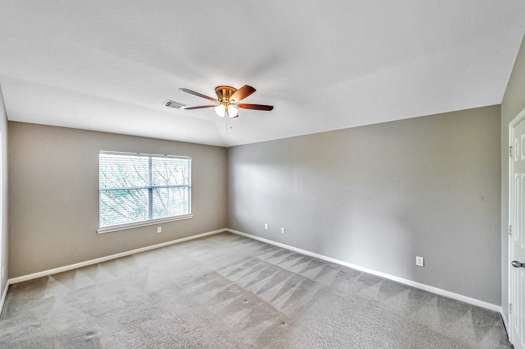 20243 Sunset Ranch Drive Katy, TX 77449 - Photo 22 of 36 an empty room with a window and a chandelier