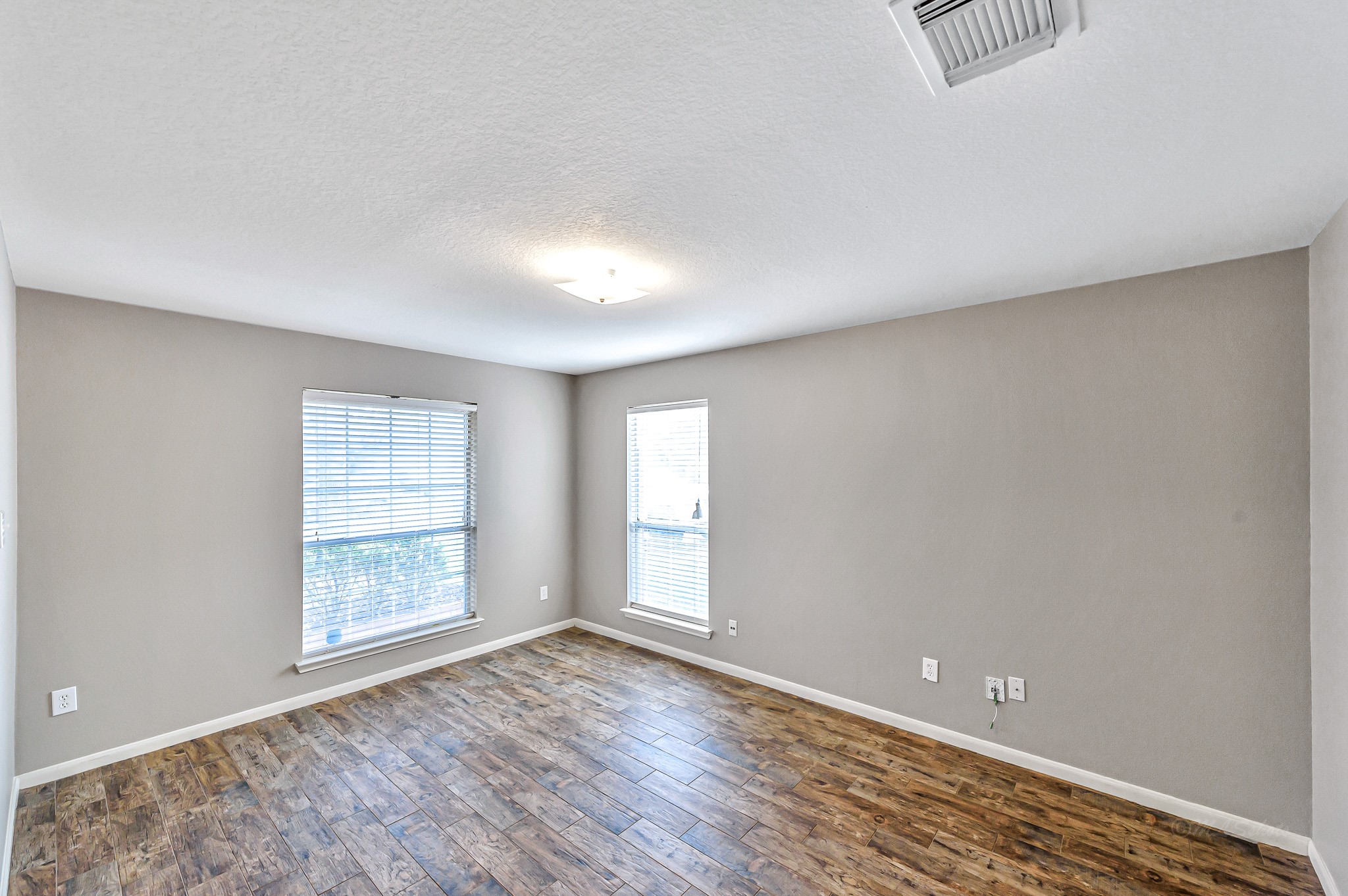 20243 Sunset Ranch Drive Katy, TX 77449 - Photo 6 of 36 an empty room with wooden floor and windows