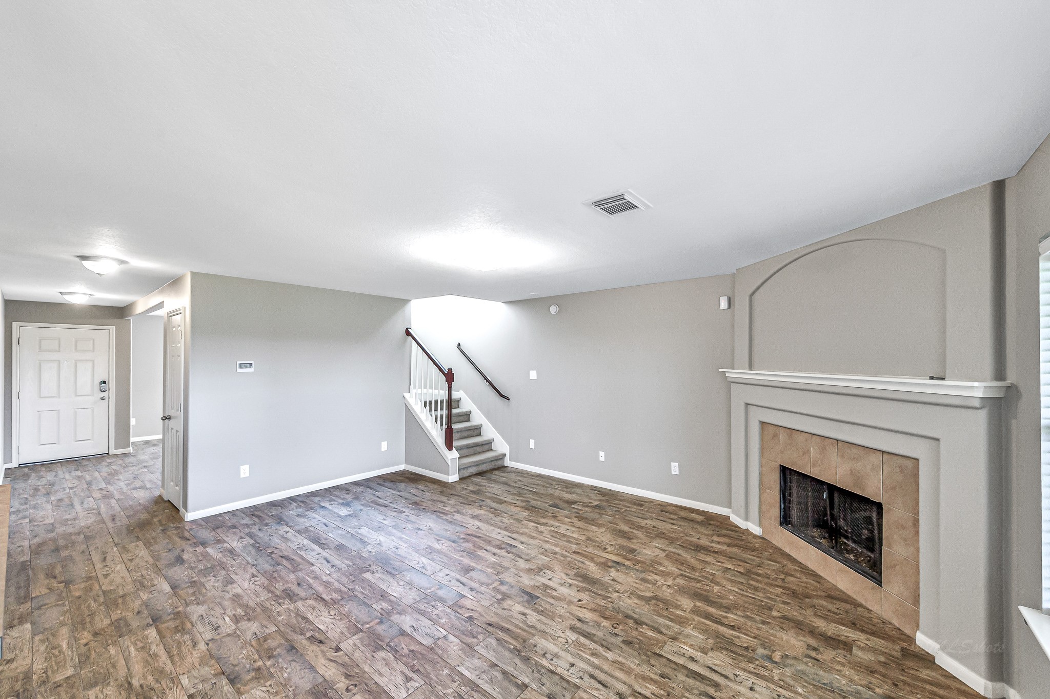 20243 Sunset Ranch Drive Katy, TX 77449 - Photo 9 of 36 a view of empty room with a fireplace and wooden floor