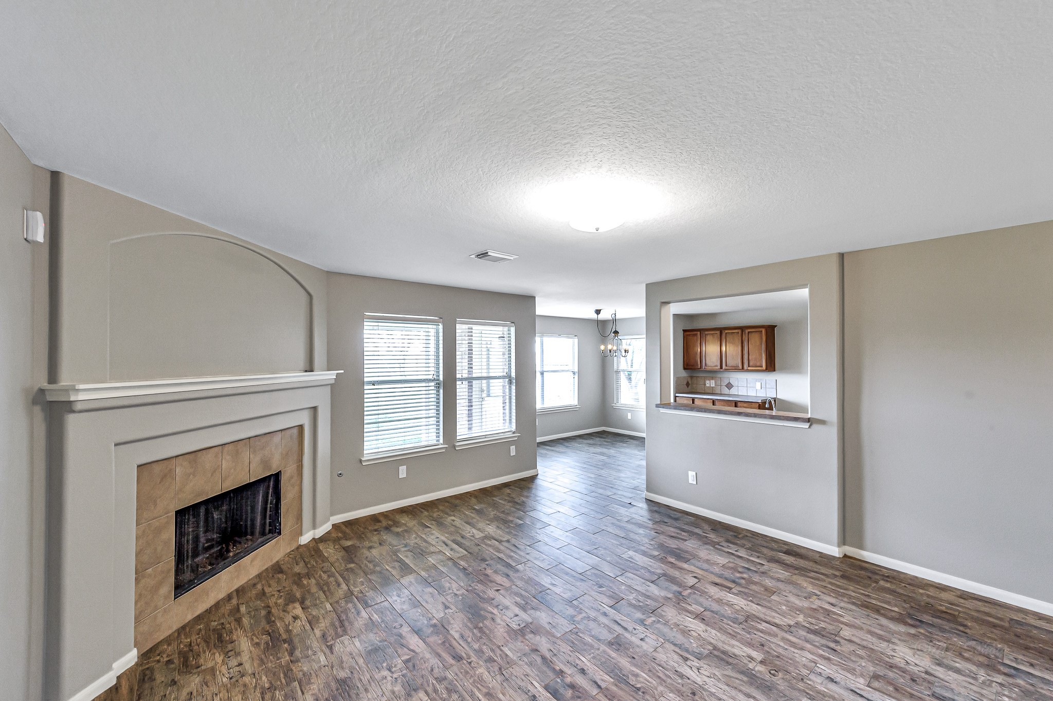 20243 Sunset Ranch Drive Katy, TX 77449 - Photo 10 of 36 a view of an empty room with a fireplace and a window