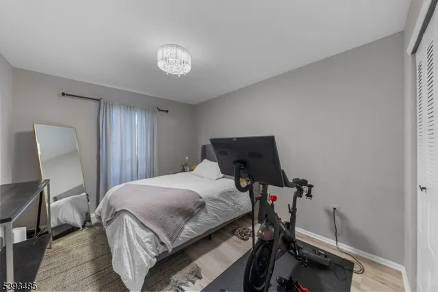 a bedroom with a bed and a chandelier