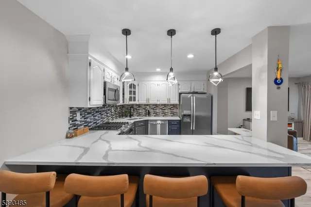 a kitchen with stainless steel appliances kitchen island furniture and wooden floor