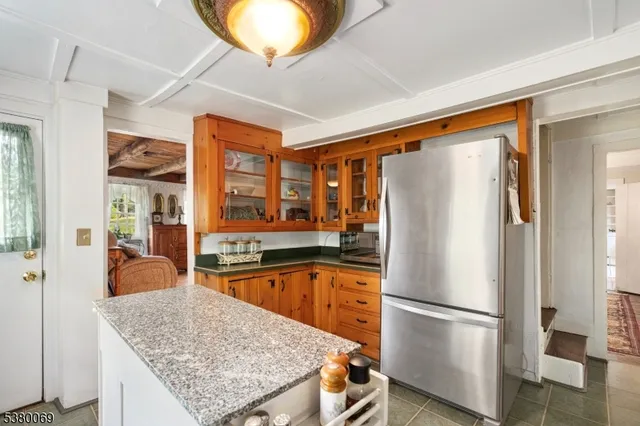 a kitchen with stainless steel appliances granite countertop a refrigerator a oven and a sink with granite countertops