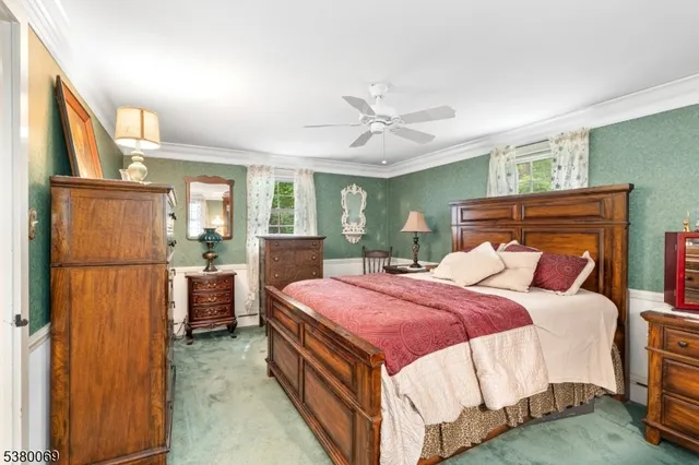 a bedroom with a bed a window and dresser