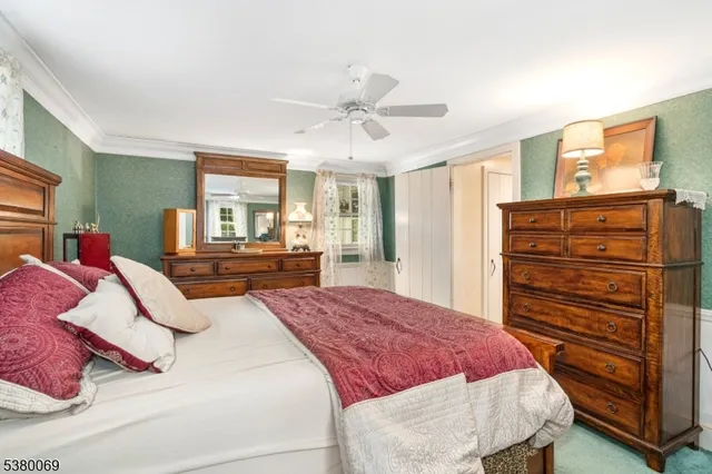 a bedroom with a bed dresser and a window