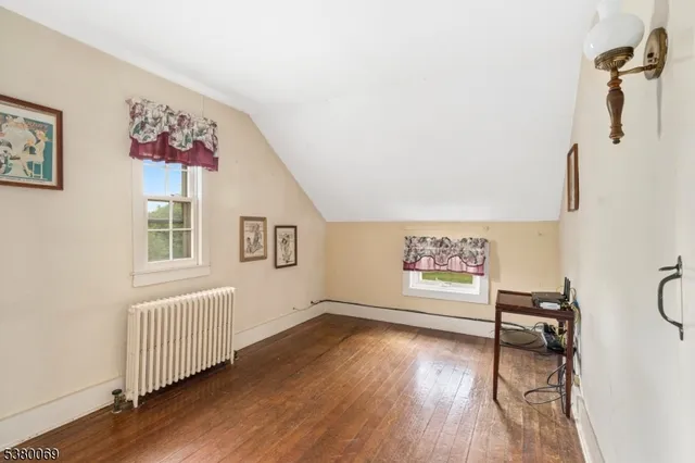 a view of a livingroom with wooden floor and a window
