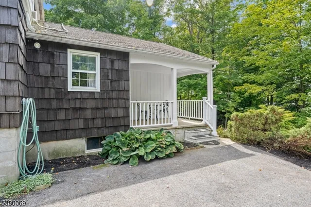 a view of a house with a small yard and a large window
