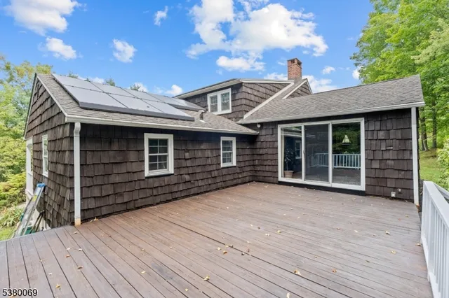 a view of a house with a large window and wooden floor