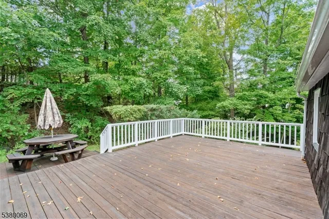 a view of backyard with a deck and wooden floor
