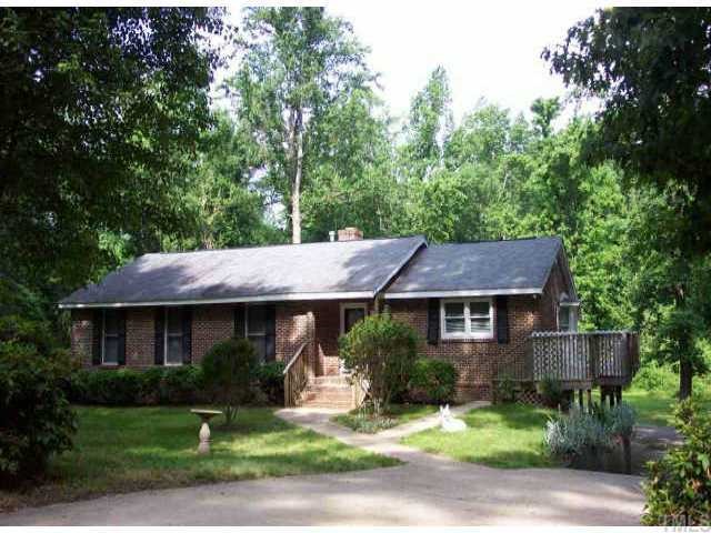 1407 Baker Road Raleigh, NC 27607 - Photo 1 of 1 a front view of a house with a yard and a tree