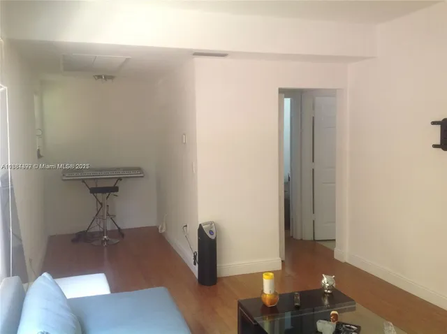 a living room with couch and a potted plant