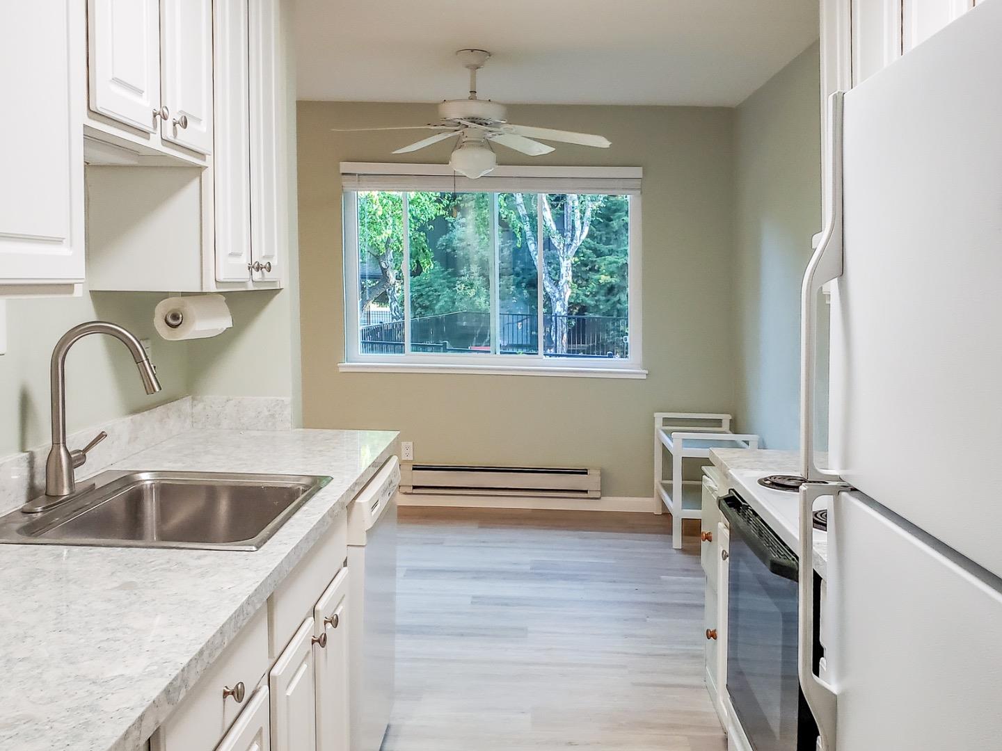 50 East Middlefield Road, Unit 4 Mountain View, CA 94043 - Photo 5 of 12 a kitchen with a stove a sink and a window