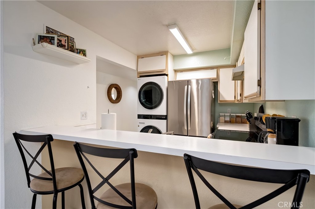 15000 Downey Avenue, Unit 343 Paramount, CA 90723 - Photo 17 of 39 a kitchen with a table chairs and a refrigerator